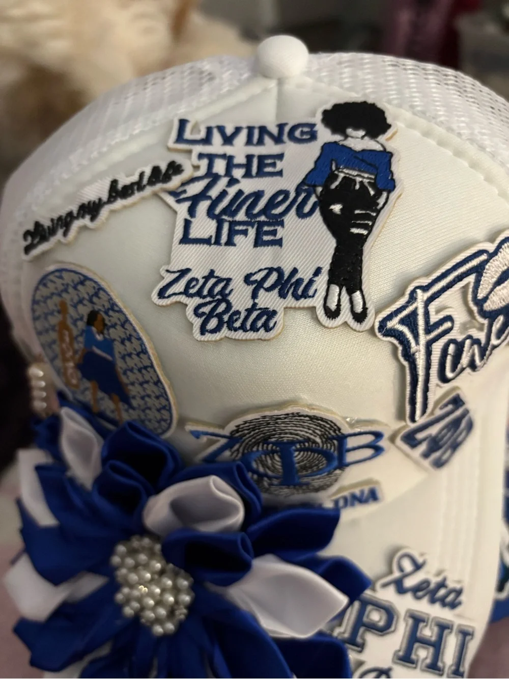 White Hat with Blue & White Flower Appliqué